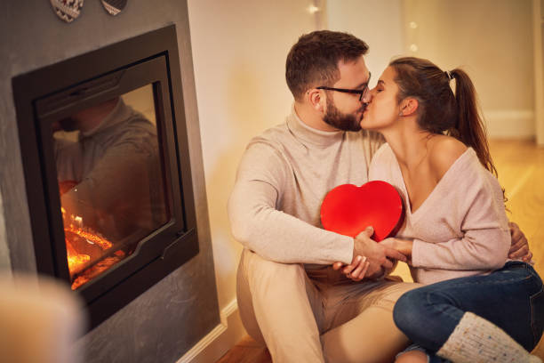 istock Adult couple with present over fireplace 1283861588