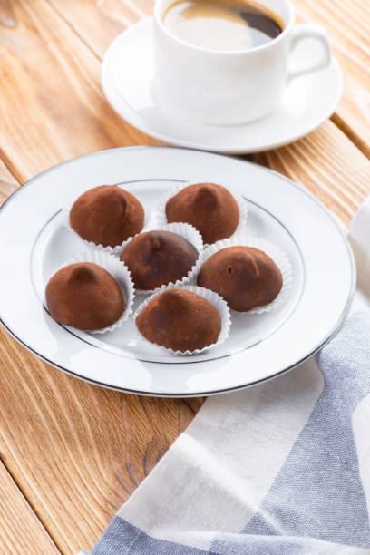 istock Chocolate truffles sweets in plate on wooden table 1283862197