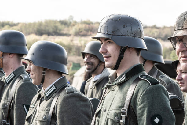 Veliko Tarnovo, Bulgaria - Actors depicting Nish operation. Re-enactors dressed as World War II Bulgarian soldiers walks on forest road. Veliko Tarnovo, Bulgaria - October 17, 2020:Actors depicting Nish operation. Re-enactors dressed as World War II Bulgarian soldiers walks on forest road. german armed forces stock pictures, royalty-free photos & images