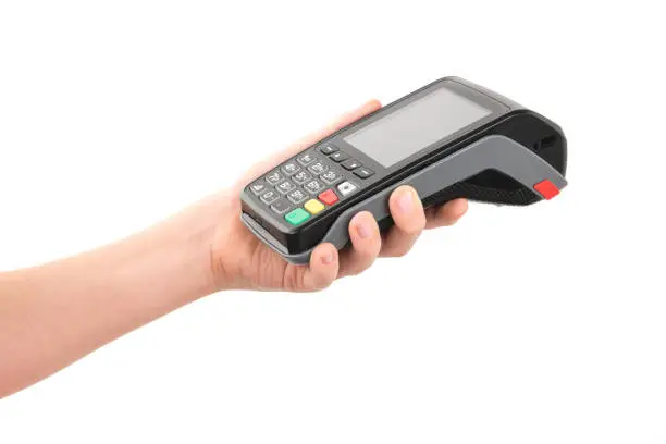 Photo of Credit card terminal in hand on white background