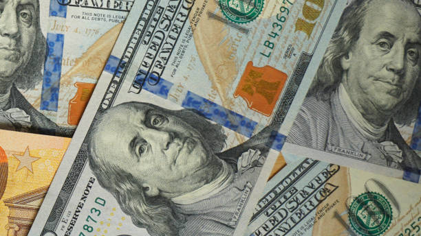 istock pile of dollar and euro banknote as background 1283863162