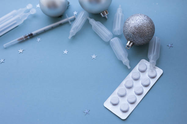 istock Blank clipboard and Christmas decorations, pills on a blue background. 1283865751