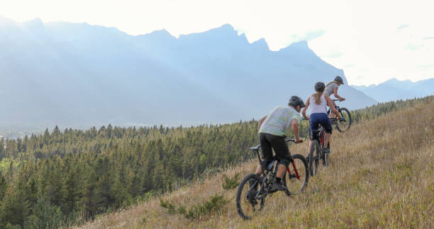 istock Mountain bikers ride along mountain ridge in the morning 1283868545