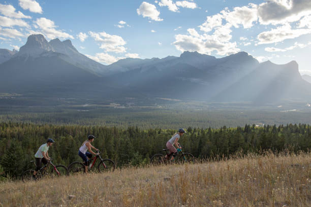 istock Mountain bikers ride along mountain ridge in the morning 1283868728