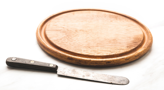 female teen hand slicing dried italian salami, wide photo