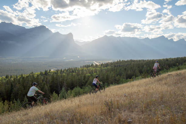 istock Mountain bikers ride along mountain ridge in the morning 1283868776