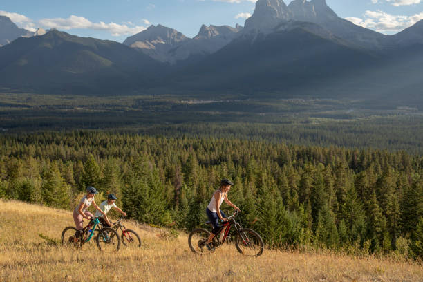 istock Mountain bikers ride along mountain ridge in the morning 1283869319
