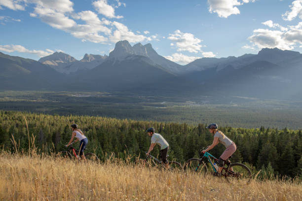 istock Mountain bikers ride along mountain ridge in the morning 1283869322