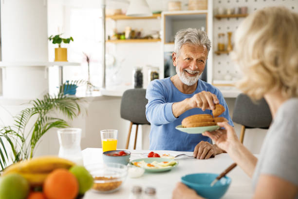 istock Senior couple having a breakfast together at home 1283869410