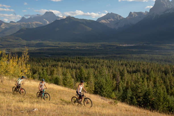 istock Mountain bikers ride along mountain ridge in the morning 1283869418