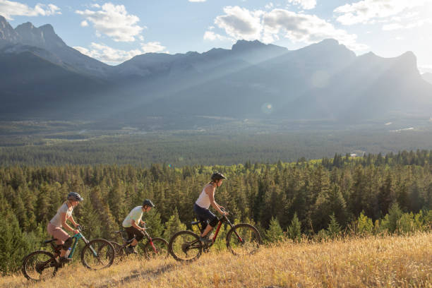 istock Mountain bikers ride along mountain ridge in the morning 1283869436