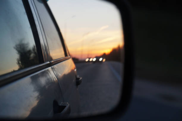 istock blurred road and sunset in car rearview mirror 1283869488