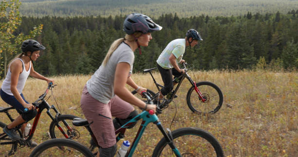 istock Mountain bikers ride along mountain ridge in the morning 1283869553
