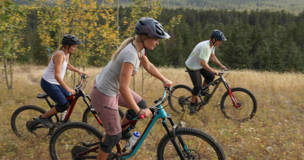istock Mountain bikers ride along mountain ridge in the morning 1283869577