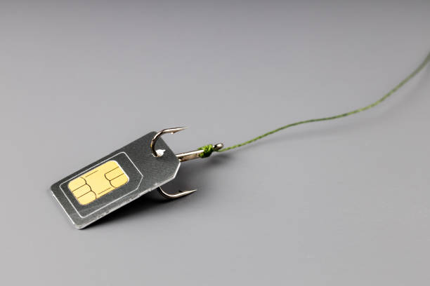 a sim card on a fishing hook to which the thread is attached - extortionist imagens e fotografias de stock