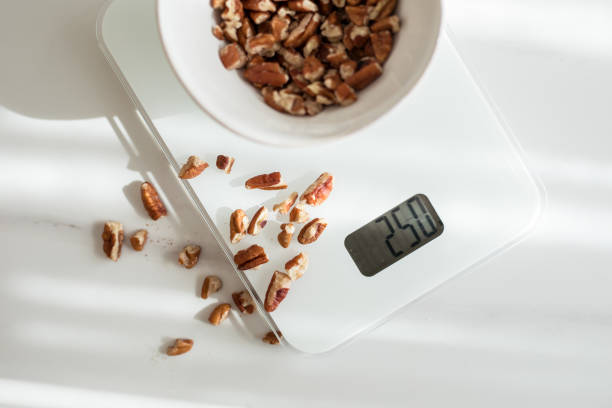 istock Nuts and oats in white ceramic bowls 1283871666