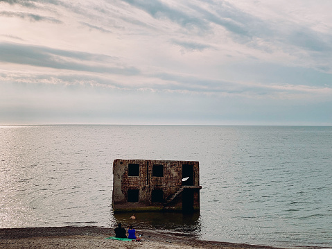 Leisure swimmers near abandoned World War I forts in Liepaja, Latvia