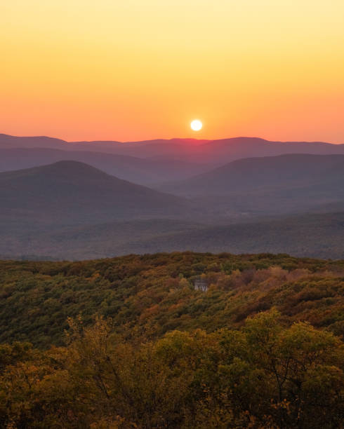 istock Warm golden sunlight shining across layers of rolling mountains during sunset. 1283872529