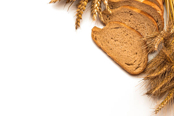 istock Rustic bread. Fresh loaf of rustic traditional bread with wheat grain ear or spike plant isolated on white background. Rye bakery with crusty loaves and crumbs. Concept - Cooking at Home. 1283873881