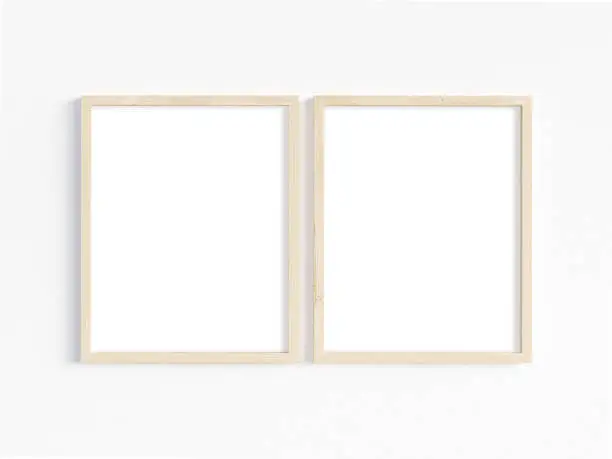 Two wooden vertical frames 8x10 on a light background. Mockup of 2 frames to display your work. 3D illustration.
