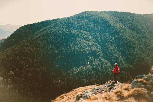Woman traveler on a walking route, active lifestyle, hiking and travel concept.