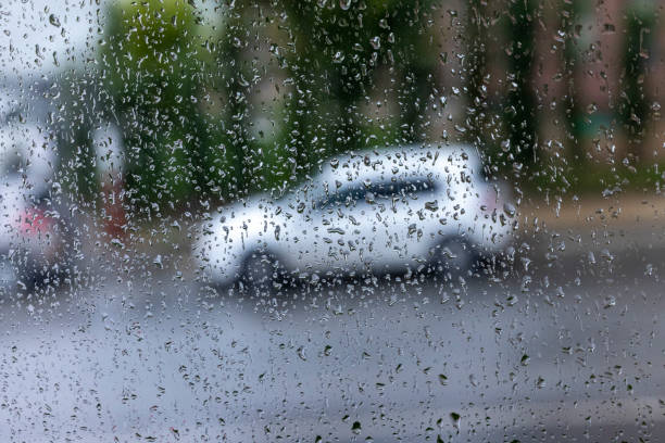 istock Rain drop rain through the glass and the street 1283880253