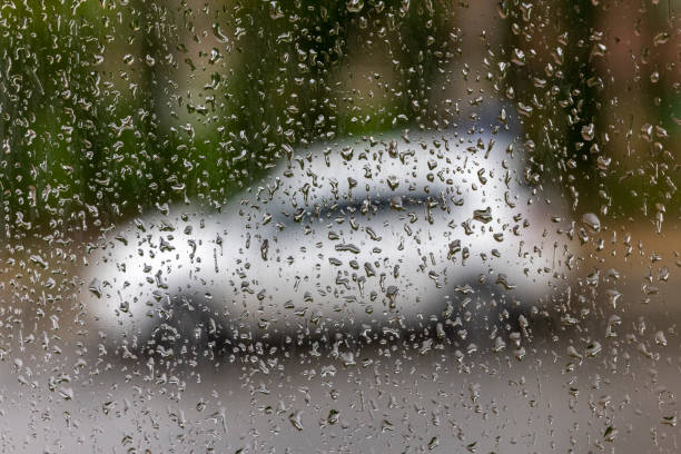 istock Rain drop rain through the glass and the street 1283880543