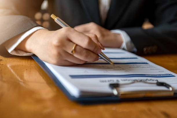 istock Closeup of Hand with pen over application form. 1283880700
