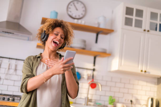 istock Young woman dancing in kitchen while listening music 1283880745