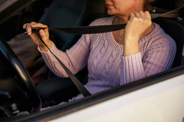 istock Adjusting the seat belt in a car 1283881668