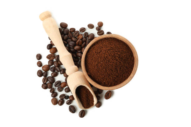 istock Wooden bowl with ground coffee isolated on white background 1283882172