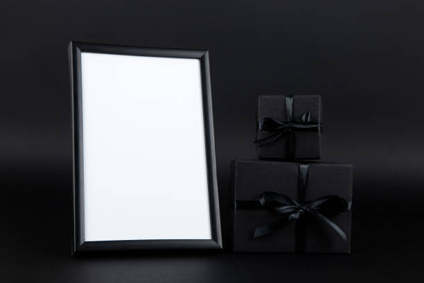 istock Black gift and mockup frame, on paper black background. Dark design concept, sales. Copy space. 1283882193