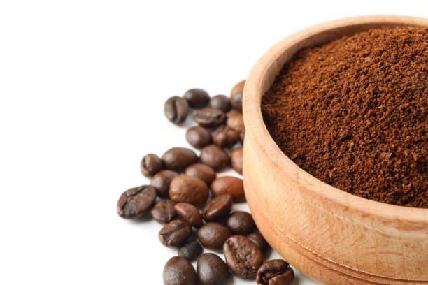 istock Wooden bowl with ground coffee isolated on white background 1283883081