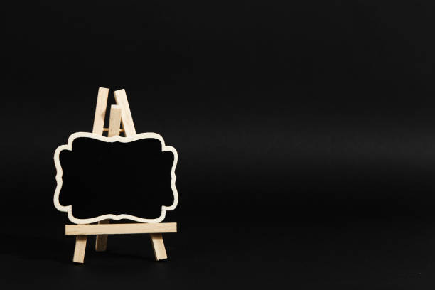 istock A frame on a stand on a black background, a blank for the design. Copy space. 1283883335