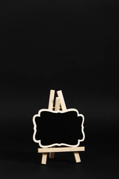 istock A frame on a stand on a black background, a blank for the design. Copy space. 1283883393