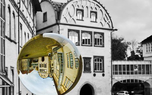 Abstract image of a large historical building in a crystal ball with black and white background