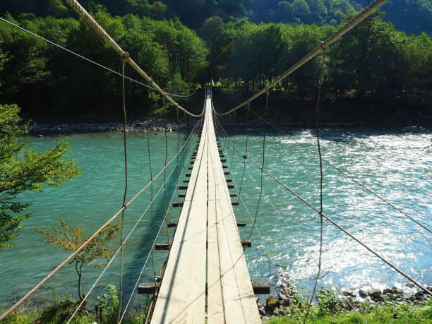 istock Suspension bridge over a mountain river in Abkhazia. 1283884544