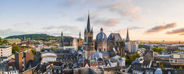 Panorama of Aachen (Cathedral, City Hall) Aachen Cathedral and City Hall at sunrise with the Ferris wheel in between and the Lousberg in the background. Aachen is an excellent destination for excursions and has a lot to offer historically. aachen stock pictures, royalty-free photos & images