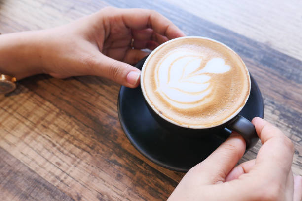 istock high angle view of women holding coffee cup. 1283884755