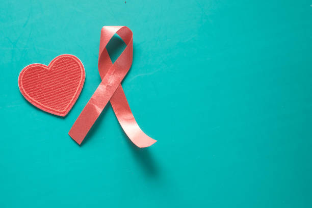istock Red ribbon HIV and heart shape on green background 1283886433