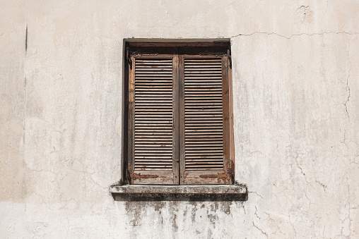 old brown window  on a gray wall