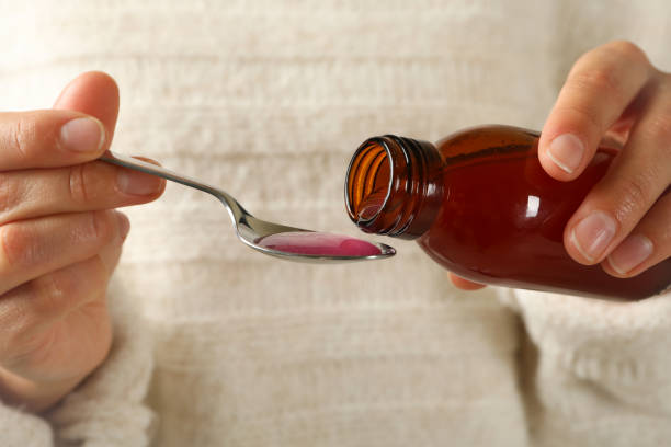 istock Woman pouring syrup in spoon, close up 1283887003