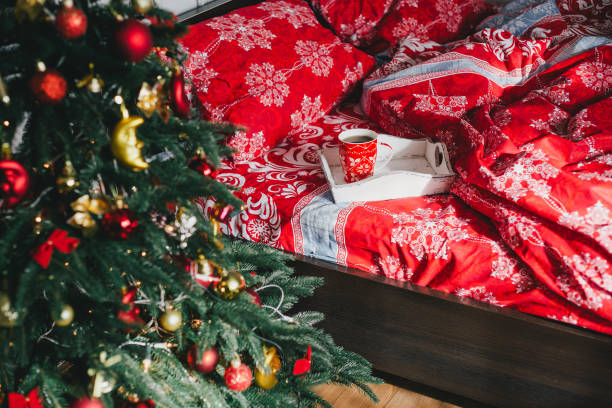 istock Holiday interior with Christmas tree in a bedroom. 1283887367