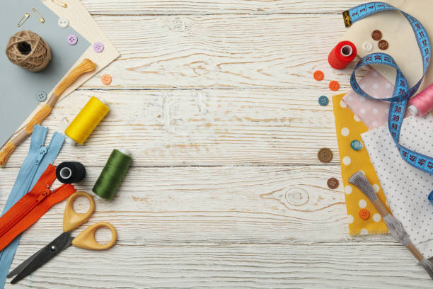 istock Sewing supplies on white wooden background, space for text 1283888993