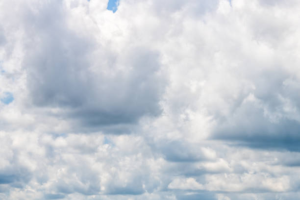 istock Isolated big white large cloud formations closeup in blue sky cloudscape skyscape looking up during day in Tampa, Florida 1283890340
