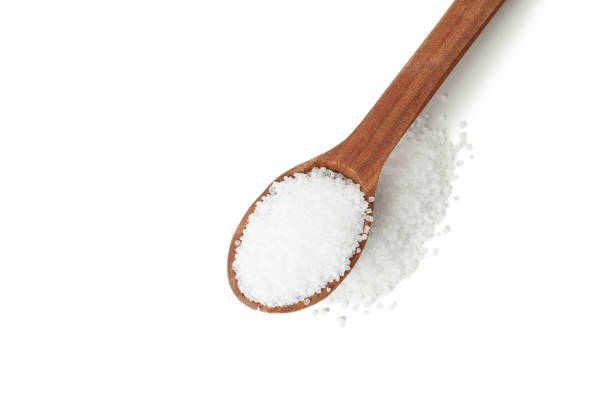 istock Wooden spoon with salt isolated on white background 1283890569