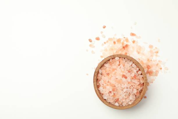 istock Bowl of pink himalayan salt on white background 1283891225
