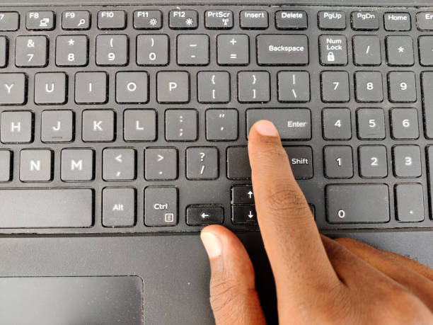 Finger pressing a Enter button on the laptop keyboard. Selective focus Finger pressing a Enter button on the laptop keyboard. Selective focus entering data stock pictures, royalty-free photos & images