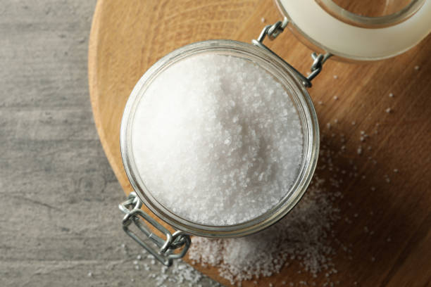 istock Board with glass jar of salt on gray table 1283891471