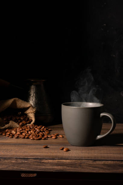 istock Cup of coffee and coffee beans on a wooden table 1283891601